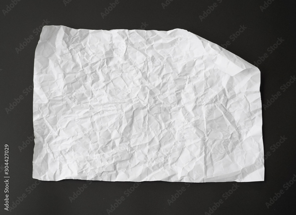 Obraz premium crumpled white paper isolated on black background. can use text banners products or business cards your.