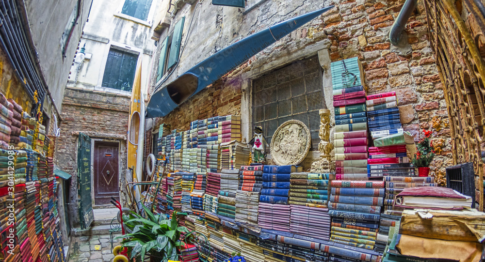 Naklejka premium VENICE - APRIL 10, 2014: Acqua Alta library with old books collection is a famous tourist attraction