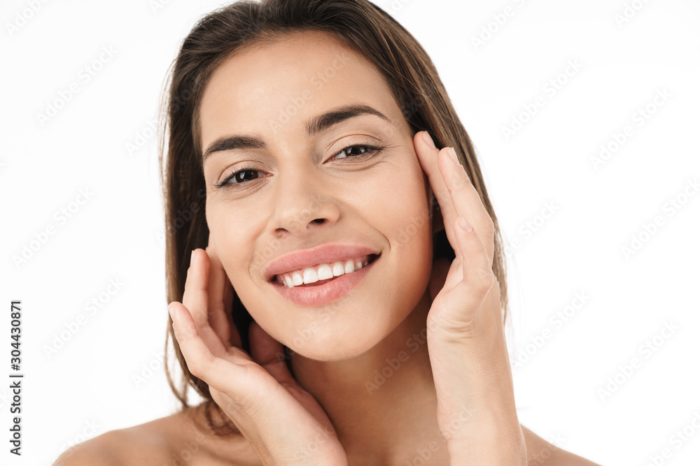 Portrait of young brunette half-naked woman smiling and touching her face Portrait of young brunette half-naked woman smiling and touching her face