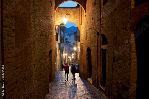 people walking in Siena by night