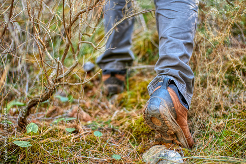 Man walking through the field among the vegetation