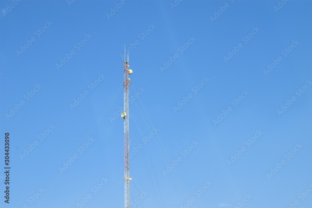 a very tall mobile tower and blue sky in the background a very tall mobile tower and blue sky in the background