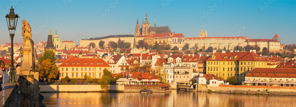 Prague - The panoramic view from Charles bridge to the Castle and Cathedral over the  Vltava river in the morning light.