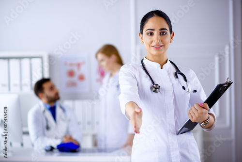 Charming arab doctor handshake with a patient