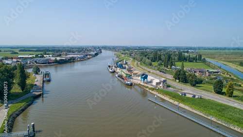 Loading barge with sand and rubble on a small berth. Freight transport logistics