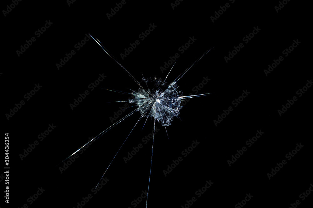 Obraz premium crack on the glass mirror in the form of abstraction on a black background