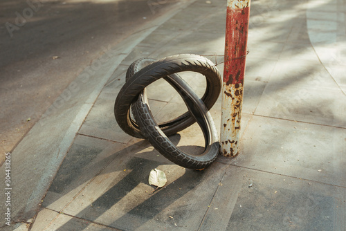 Fototapeta Naklejka Na Ścianę i Meble -  Bike tire on the street as sign of repair service