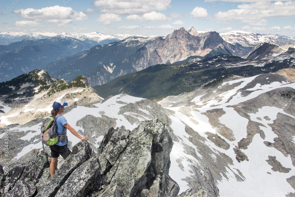 An independent sporty woman overlooking a mountain landscape in British Columbia, Canada