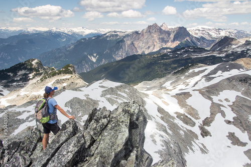 An independent sporty woman overlooking a mountain landscape in British Columbia, Canada © Tom