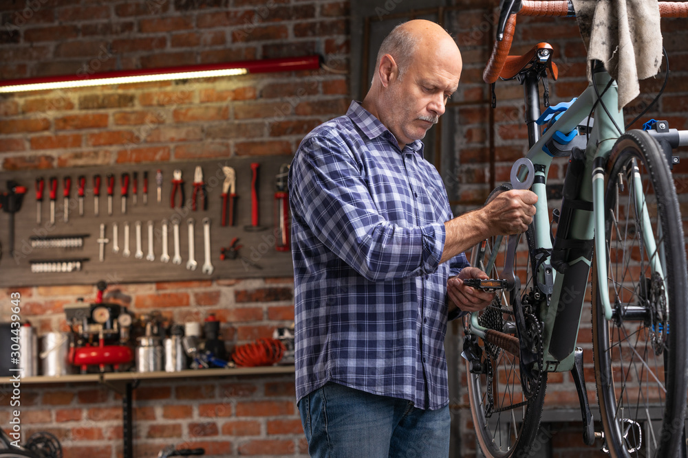 Mechanic working on a bicycle during servicing Mechanic working on a bicycle during servicing