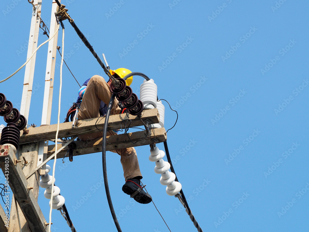 electrician man working at height and dangerous ,high voltage power line maintenance