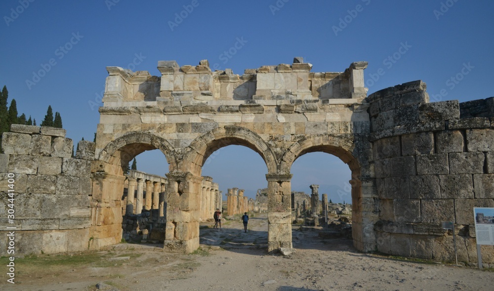 Old Hierapolis ruins, amphitheatre and touristic locations captured with hill background, in daytime.