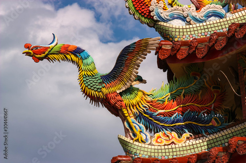 A traditional Chinese phoenix decoration on top of a Taiwanese Temple, Taiwan. photo