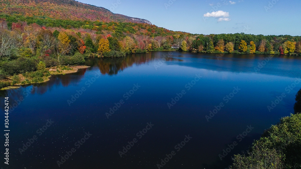 Aerial drone view of lake in autumn state park.