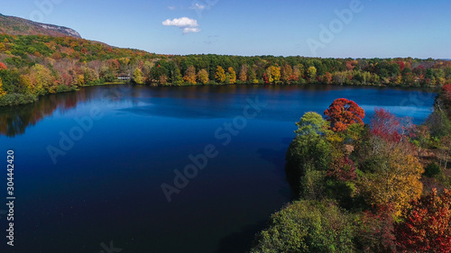 Aerial drone view of lake in autumn state park.