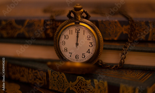 Vintage Antique clock placed with Arabic books in background