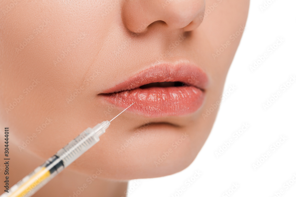 Naklejka premium cropped view of woman near syringe isolated on white