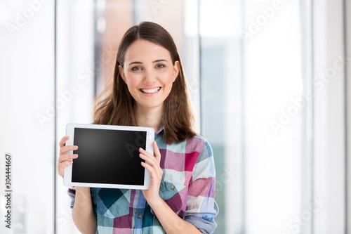 Businesswoman showing digital tablet in office