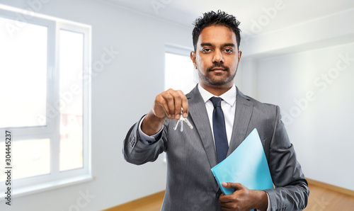 Wallpaper Mural real estate business and people concept - indian man realtor with keys and folder over empty new apartment room background Torontodigital.ca