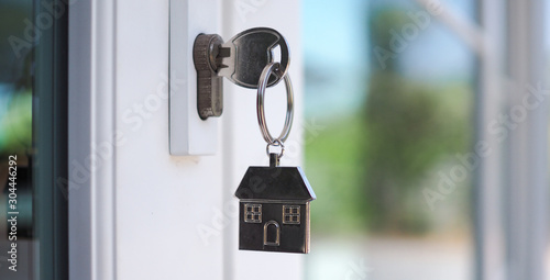 The house key for unlocking a new house is plugged into the door.        © Shisu_ka