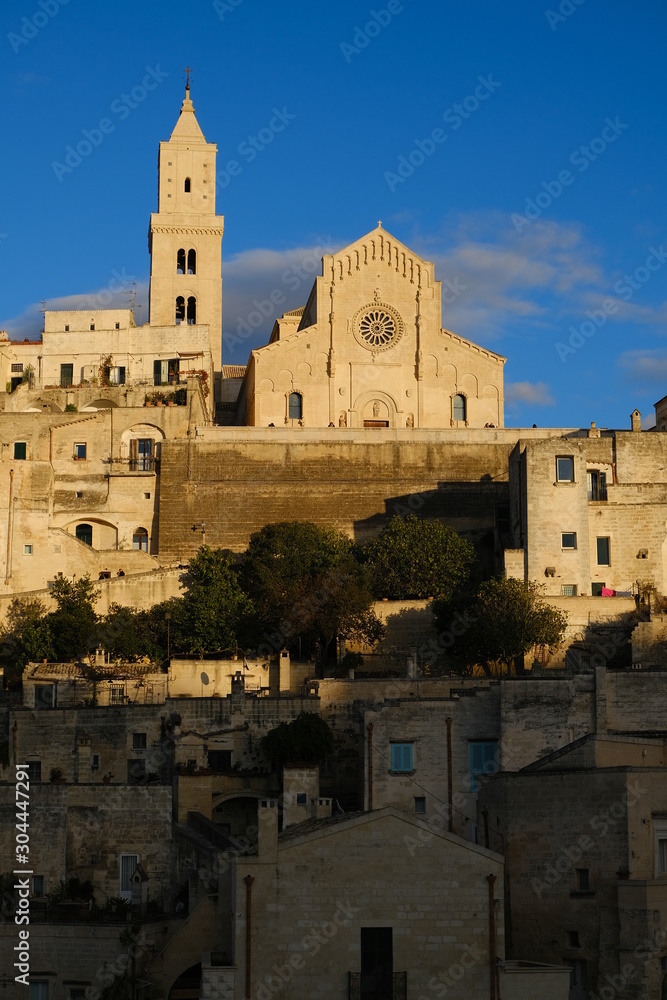 Houses, church and bell tower in the city of Matera in Italy. The tuff blocks are the material used for the construction of the houses.