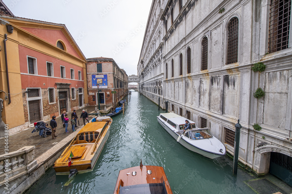 VENICE, ITALY - APRIL 2014: Boats along the city canals in spring