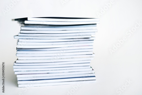 Stack of books on a white background, soft focus