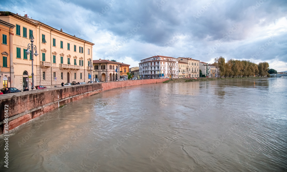 Swollen River Arno in Pisa at sunset, Bad Weather on Tuscany, Italy