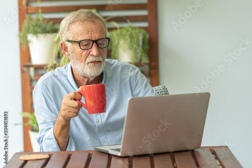 Portrait senior man using laptop for working at home, Freelance concept - Image