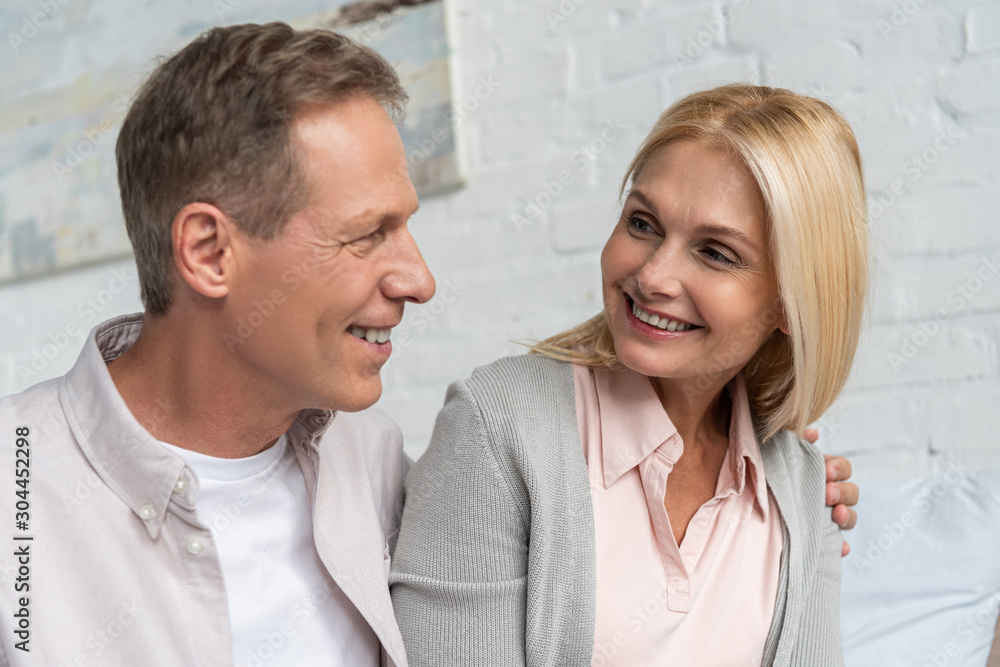 Smiling couple looking at each other at home Smiling couple looking at each other at home