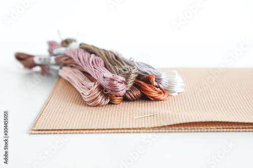 flatlay creativity: canva aida beige and multi-colored thread mouline thread, cross-stitch