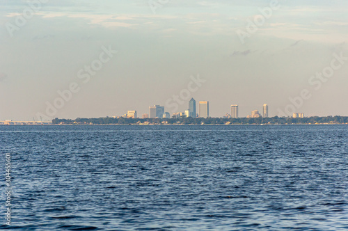 View of the city of Jacksonville  Florida  from the distance  while sailing on the Saint John s river on a sunny afternoon. United States