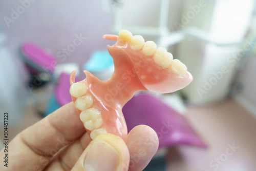 removable denture in the hands of a doctor