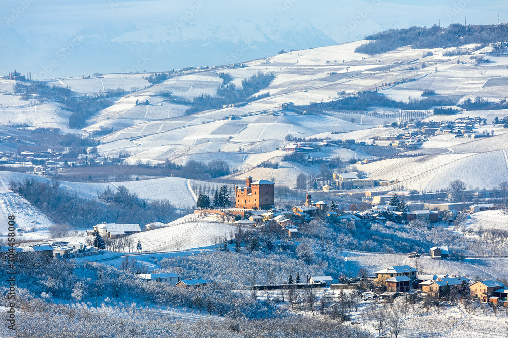 Hills and vineyards of Langhe area covered in snow in Italy.