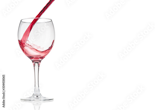 Red wine pouring  into glass on white background