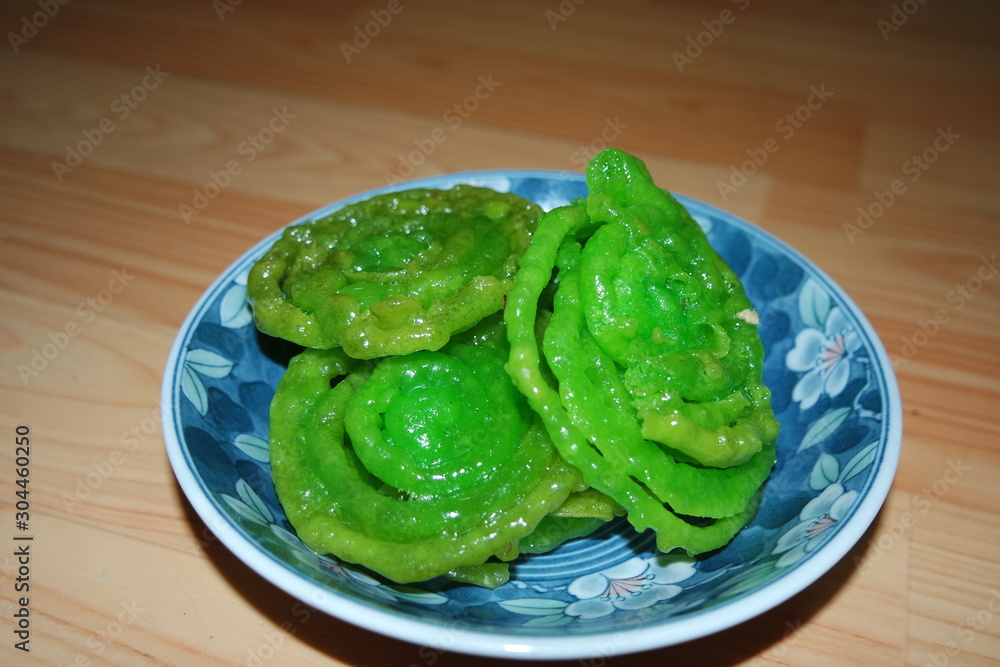 Crispy sweet Asian dessert green Jalebi cooked and served in ceramic plate. Crispy sweet Asian dessert green Jalebi cooked and served in ceramic plate.