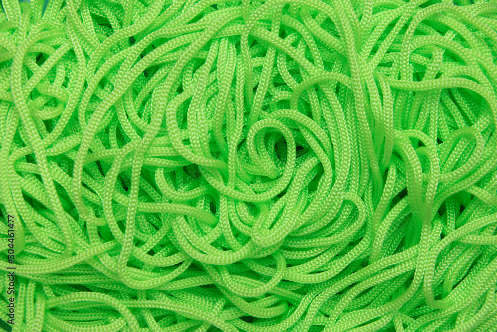 Background of textile cords of bright green color.