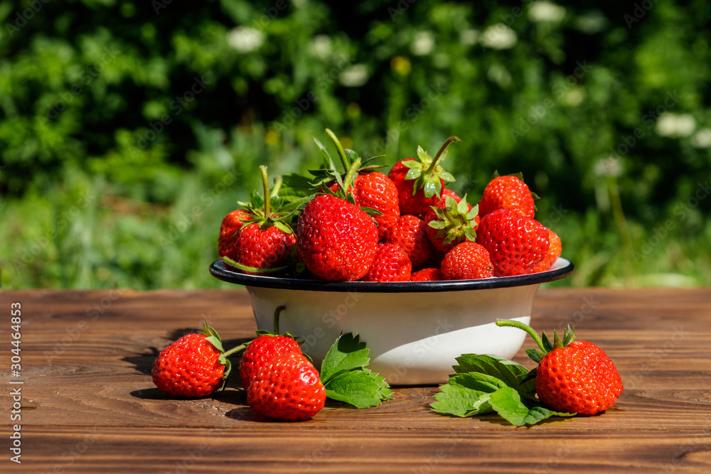 Fresh ripe strawberry on a wooden table outdoor Fresh ripe strawberry on a wooden table outdoor