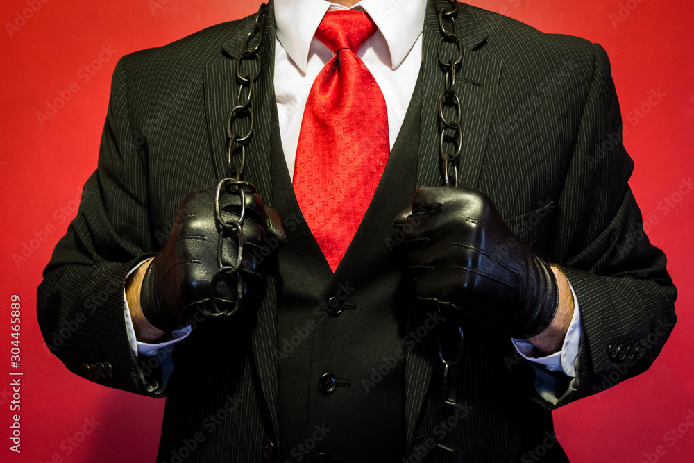 Portrait of Hitman in Dark Suit and Red Tie and Leather Gloves Holding  Chain Around His Shoulders. Hitman Ready for Violence. Threat of Danger.  Dark Stock Photo. Photos | Adobe Stock