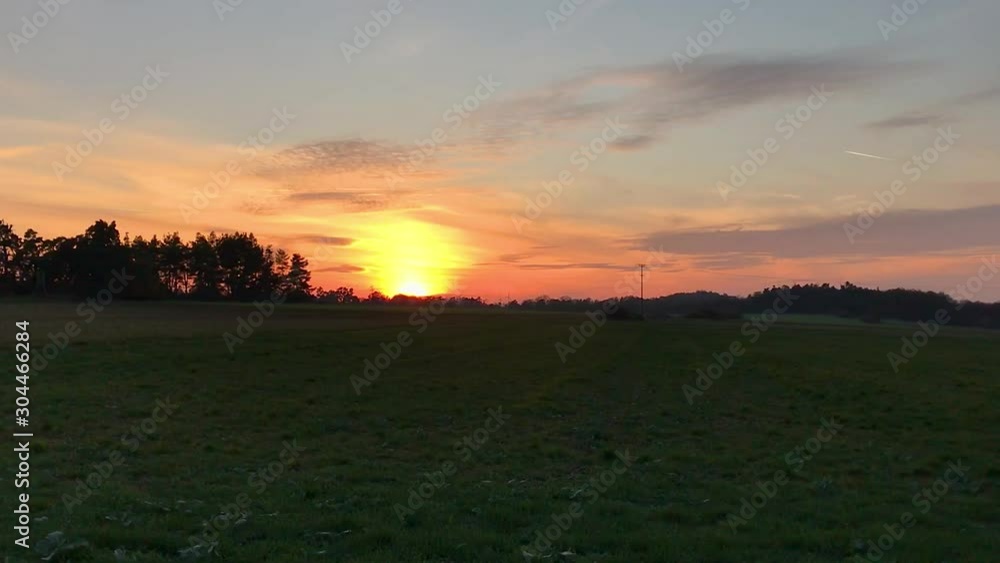Sunset with sun in colorful sky over hill on fields (Full HD) Sunset with sun in colorful sky over hill on fields (Full HD)