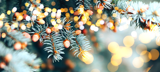 Christmas tree outdoor with snow, lights bokeh around, and snow falling, Christmas atmosphere.