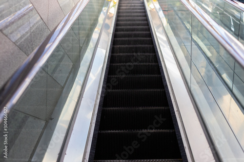 Empty escalator. Minimalism, street photography. Escalator steps. Conceptual photo. Lazy climb.