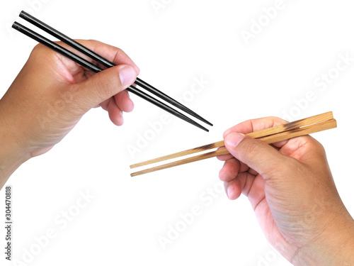 Hand holding wooden chopsticks isolated on white background