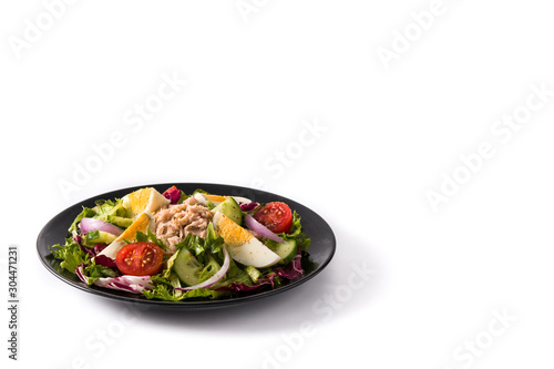 Salad with tuna, egg and vegetables isolated on white background. Copy space