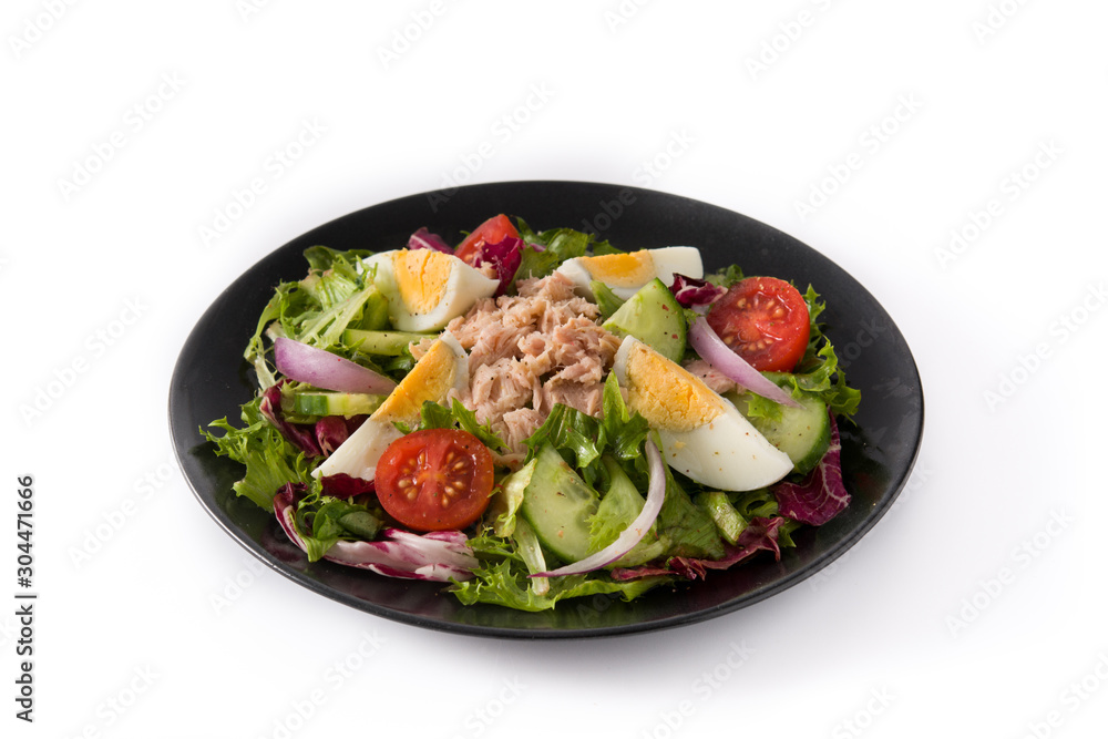 Salad with tuna, egg and vegetables isolated on white background
