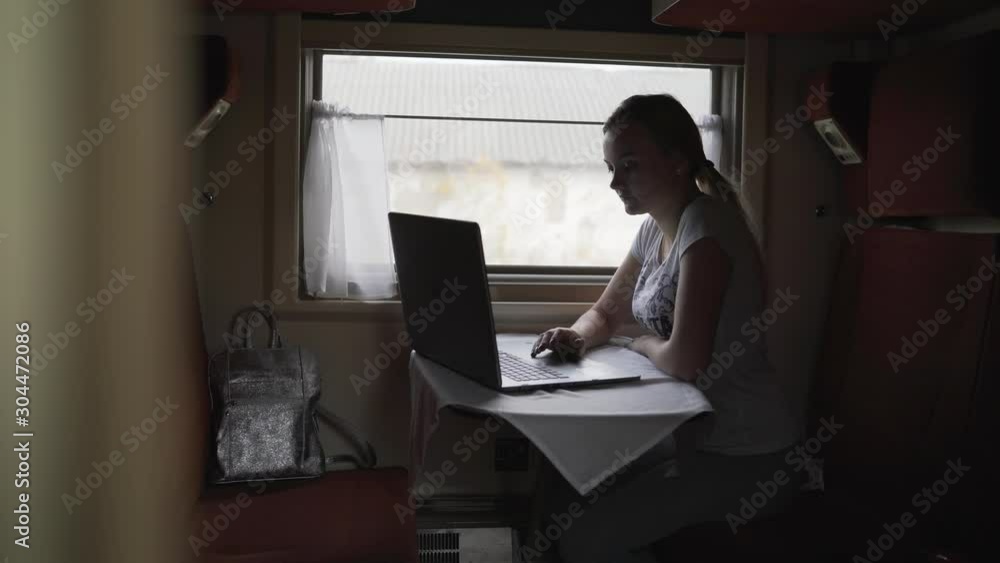 Teen girl sitting in compartment car of train in summer, traveling. The girl in the train in the compartment. Teen girl sitting in compartment car of train in summer, traveling. The girl in the train in the compartment.