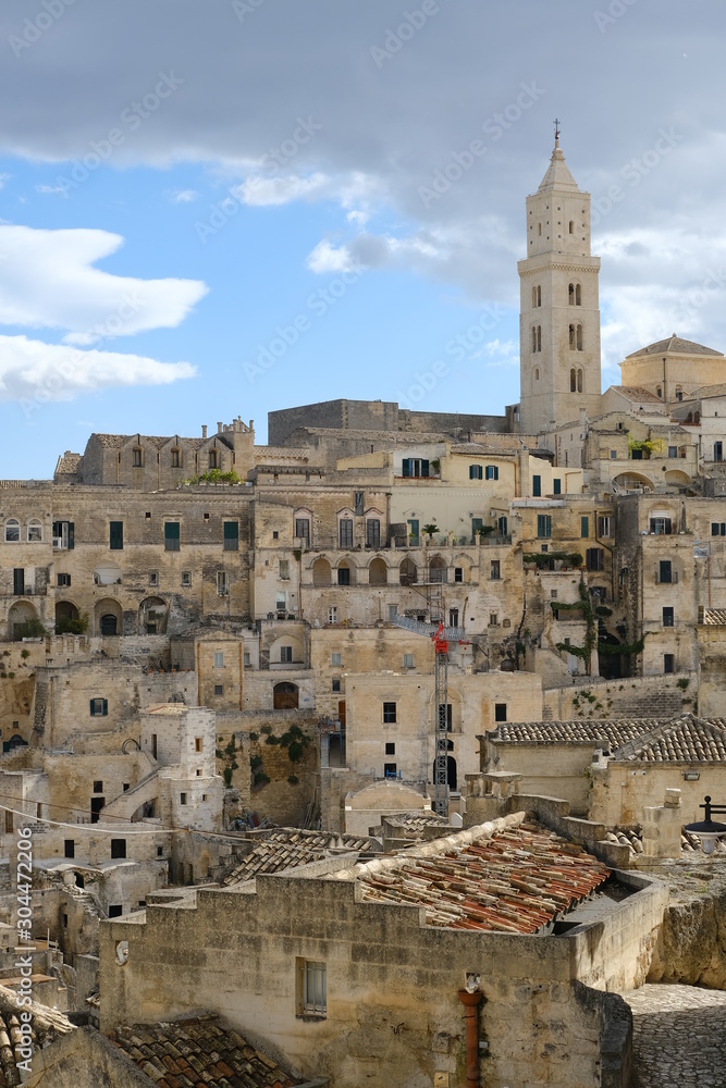 Obraz premium View of the city of Matera in Italy. Church with bell tower and houses built in beige tuff stone.