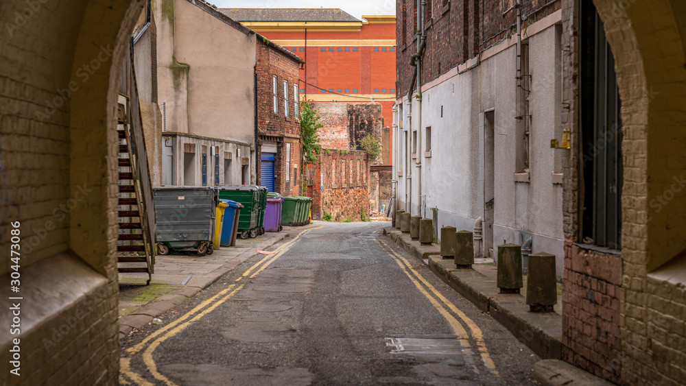 A small road with garbage containers on the side, seen in Carlisle, Cumbria, England, UK