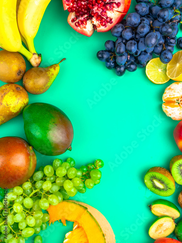 Fruits and vegetables rich in antioxidants  vitamin and fiber on trendy mint green background. Flat lay style. Super food