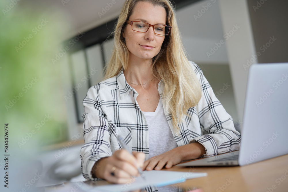 young woman working in front of her computer young woman working in front of her computer